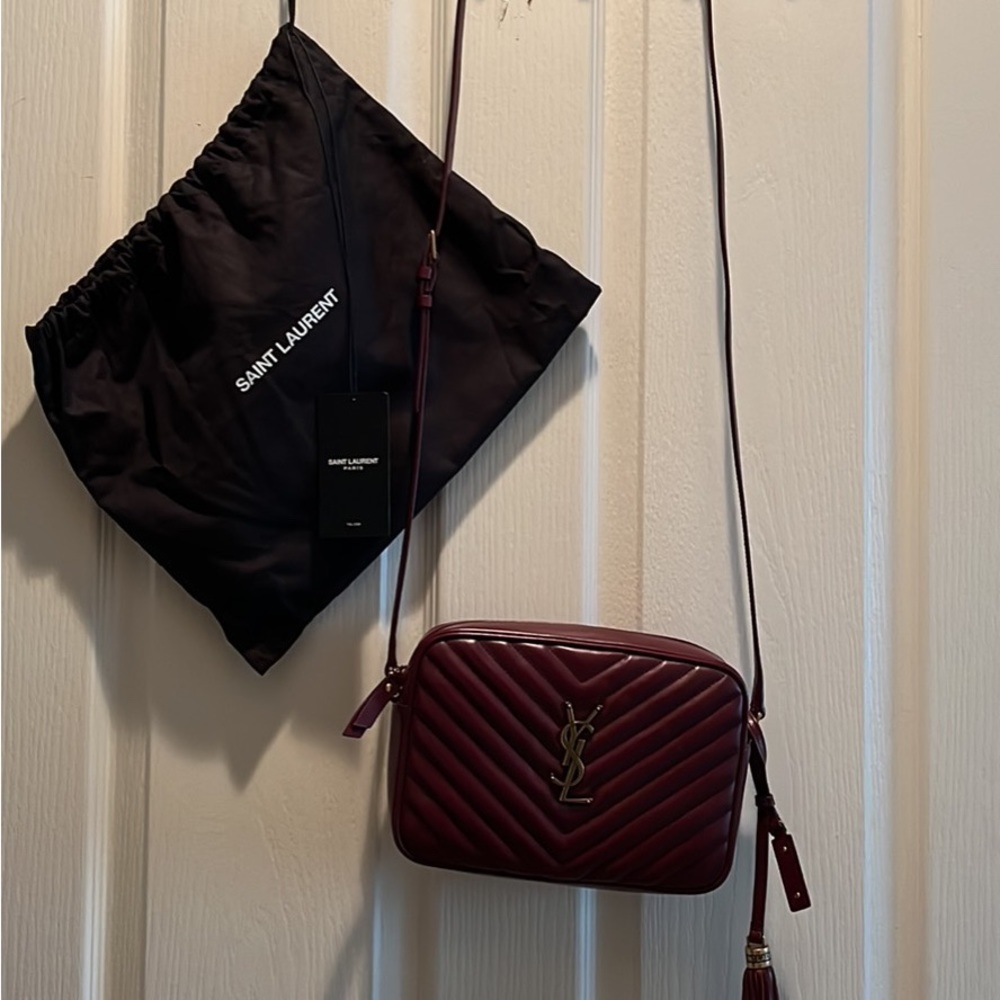 Lou Medium YSL Quilted Camera Crossbody Bag with Pocket retail at $1690 + tax.